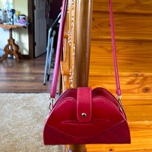 Red small purse. Not real leather. Shoulder strap.